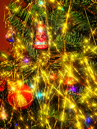 Christmas tree decorated with glitter, lights and glass balls for the Christmas and New Year celebrationsの写真素材
