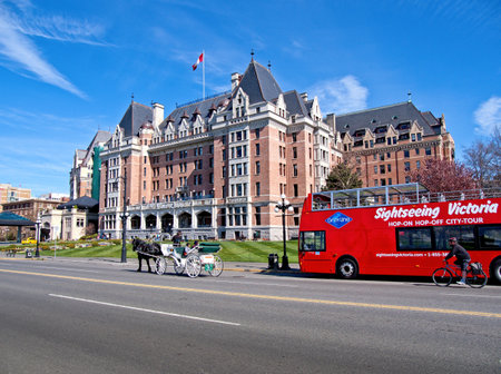 Victoria BC, Canada - March 29, 2019. Tour bus and horse carriage in front of Empress Hotel downtown Victoriaのeditorial素材