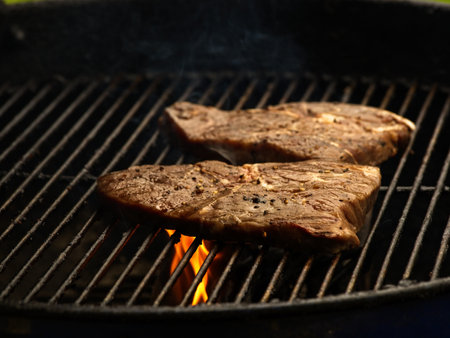 Pork chops grilled on open flame on the charcoal barbequeの写真素材