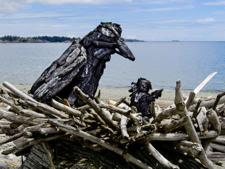 Victoria BC, Canada - May 12, 2021. Driftwood sculptures along the beach of Esquimalt lagoonのeditorial素材