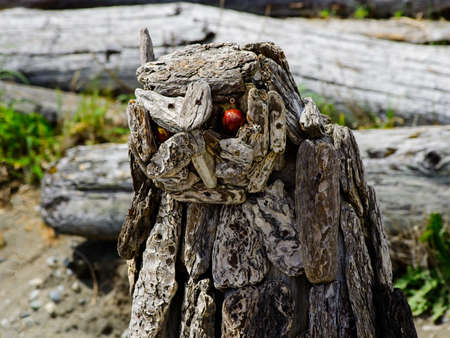 Victoria BC, Canada - May 12, 2021. Driftwood sculptures along the beach of Esquimalt lagoon
