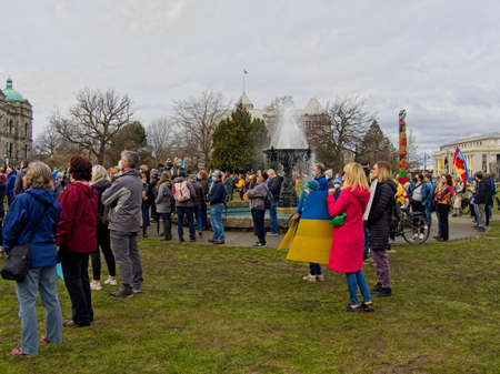 Victoria BC, Canada - February 27, 2022. Demonstration of protest against Russia war in Ukraine on the lawn of Legislative Building in Victoria BCのeditorial素材