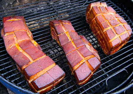 Pork belly being smoked on the charcoal grillの写真素材