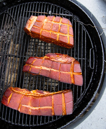 Pork belly being smoked on the charcoal grillの写真素材