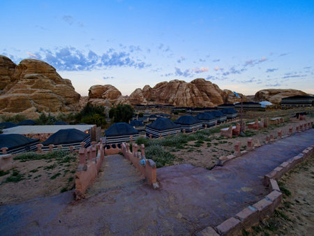 Bedouin camp near Petra, Jordan among orange sandstone cliffs at the sunriseの写真素材