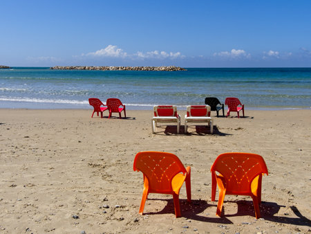 Chairs and lounges at the spectacular sandy beach of Netanya, Israel. Mediterranean coast on a sunny dayの写真素材
