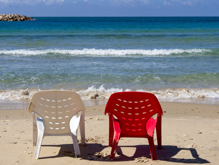 Chairs and lounges at the spectacular sandy beach of Netanya, Israel. Mediterranean coast on a sunny dayの写真素材