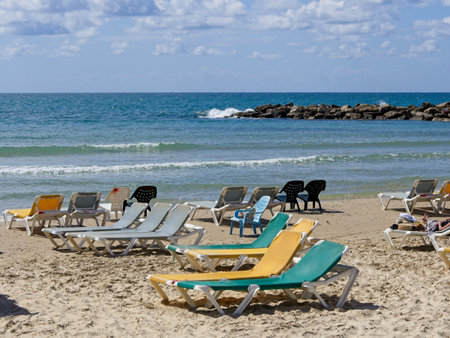 Chairs and lounges at the spectacular sandy beach of Netanya, Israel. Mediterranean coast on a sunny dayの写真素材