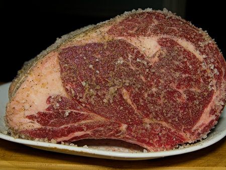 Beef prime rib roast in stages of preparation: seasoningの写真素材