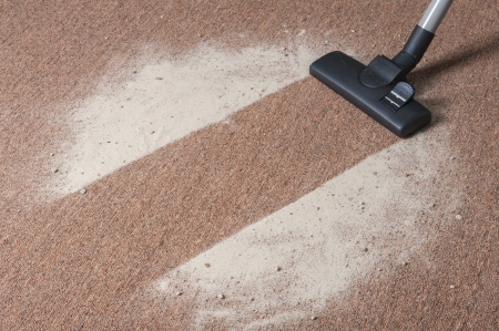 Vacuum cleaning dirt on a carpetの写真素材