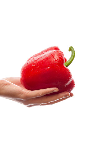 Girl holding isolated red pepper on a white backgroundの写真素材