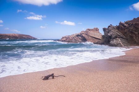 Seascapes showing clear blue water hitting the sand beach coast of Andros island in Greece. Shot...