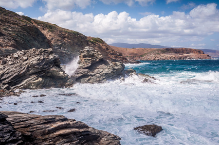 Seascapes showing clear blue water hitting the coast of Andros island in Greece. Shot during a beautiful, sunny day. Perfect for tourist attractionの写真素材