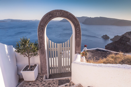 Beautiful arched entrance in one of the small streets in Oia, Santorini, Greeceの写真素材