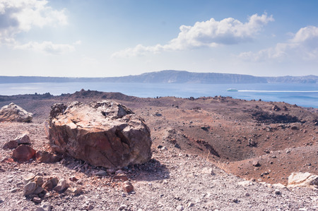 Landscape of an uninhabitated volcanic island Nea Kameni near Santorini, Greece on a sunny dayの写真素材