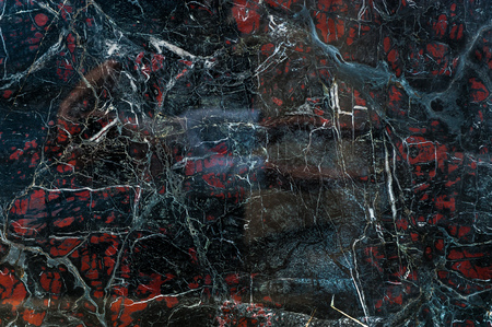 Black marble onyx texture with white cracks and red spots