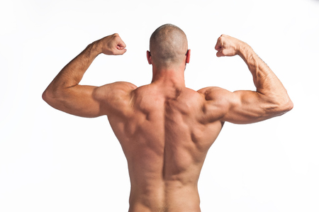 Photo of a strong bald man with big muscles flexing his arms on white background. View from the backの写真素材
