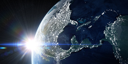 Sunrise in space. View on the night Earth with city lights glowing on the dark side. North America,...