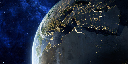 Sunrise in space. View on the night Earth with city lights glowing on the dark side. Europe, North...