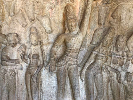 Bas relief rock cut sculptures of gods, people and animals are carved prominently in the monolithic cave temples at Mahabalipuram, Tamil nadu, Indiaの写真素材