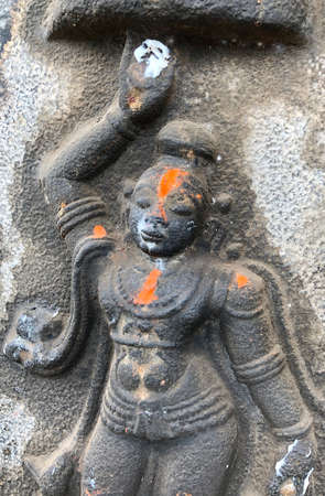 Bas relief sculpture of Hindu God carved in the walls of Shiva temple at Tamil nadu