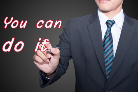 You can do it on blackboard with businessman finger pointingの写真素材