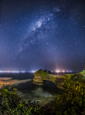 Milkyway Batu Bolong small temple near Tanah Lot temple in Bali. The temple  built on a big rock in beachの写真素材