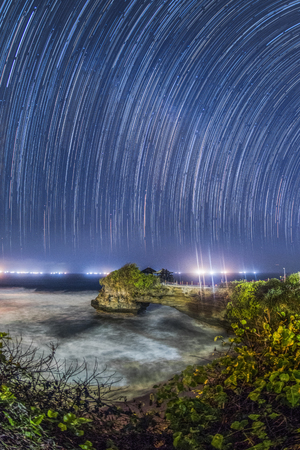 star trail  Batu Bolong small temple near Tanah Lot temple in Bali. The temple  built on a big rock in beachの写真素材