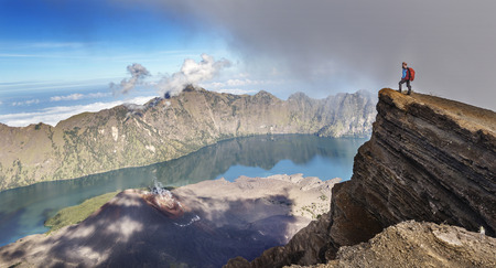Hiker enjoying the breathtaking view of Mt Rinjani near summit, Indonesiaの写真素材