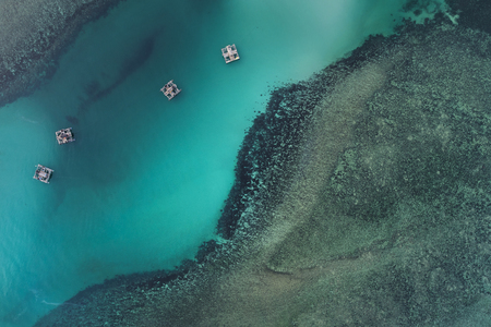 Fishing boats floating in sea from above, Bintan Island, Indonesiaの写真素材