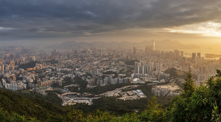 Dense high rise apartments in Kowloon peninsula view from Beacon hill in the evening, Hong Kongの写真素材