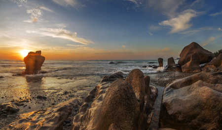Rock beach beautiful sunrise spot in Mui Ne, Vietnamの写真素材
