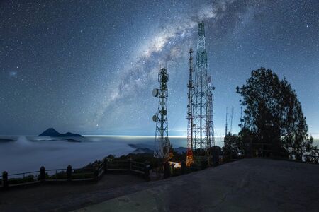 Mount Bromo covered with mist and milky way galaxy stars shining in the sky at night, Java Indonesiaの写真素材
