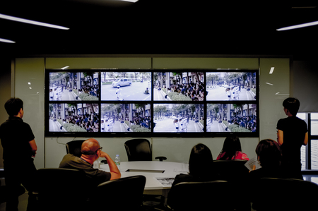 BANGKOK, THAILAND, OCT 14, 2016 - Reporters in The Nation editorial watching the Thousands mass along streets as his Majesty's body was taken from Siriraj Hospital to the Grand Palace on live TV.のeditorial素材