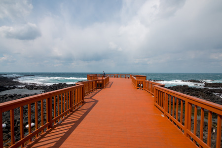 Waves hitting sea coast at Yongdamsam-dong, Jeju Island, South Korea, waves smashing volcanic rocks in the winter. Lonely day.の写真素材