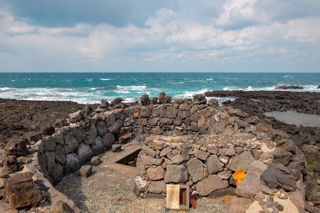 Waves hitting sea coast at Yongdamsam-dong, Jeju Island, South Korea, waves smashing volcanic rocks in the winter. Lonely day.の写真素材