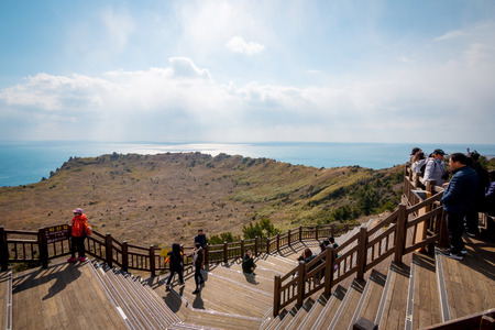 JEJU, SOUTH KOREA - March 8, 2017:  Tourist visite Seongsan Ilchulbong (Sunrise Peak). It's an archetypal tuff cone formed by hydrovolcanic eruptions upon a shallow seabed.のeditorial素材