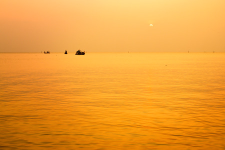 The sunset with fishing boat in the Gulf of Thailand, Bang Saen, Chonburi, Thailand.の写真素材