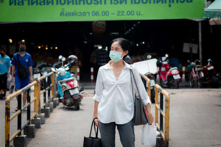 Bangkok, Thailand - April 7 2020: Daily life on street in Bangkok. People wear a mask and follow to the Social Distancing campaign to protect coronavirus disease or COVID-19 pandemic.のeditorial素材
