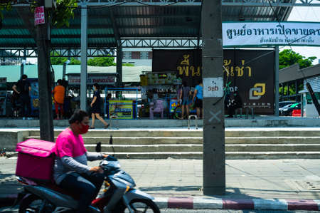Bangkok, Thailand - April 4 2020: Daily life on street in Bangkok while coronavirus disease COVID-19 pandemic. Lots of food delivery motorcycle on the road in Bangkok.のeditorial素材