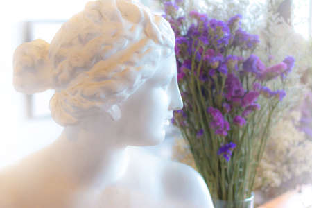 Venus sculpture with purple flower