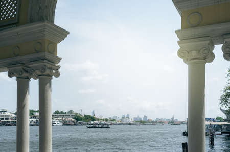 Chao Phraya River view from Siriraj Pier overlooking Wat Arun and crossing boat in the riverの写真素材