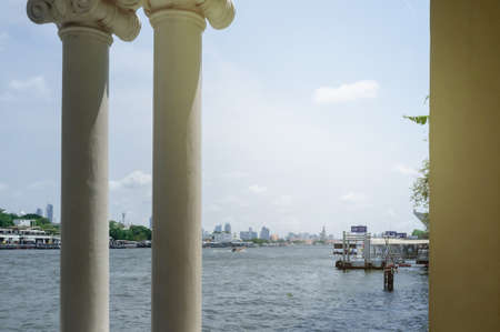 Chao Phraya River view from Siriraj Pier overlooking Wat Arun and crossing boat in the riverの写真素材