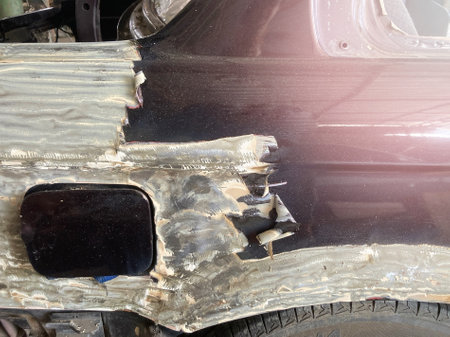 Scraping car body with paint removerの写真素材