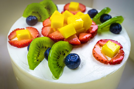 Fruit cake with strawberries, blueberries, kiwi and mangoの写真素材