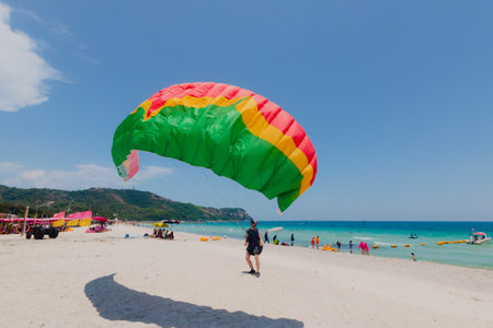 Parachutist with colorful parachute on the beach at Koh Larn, Pattaya, Chonburi, Thailand.の写真素材