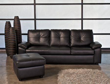 Bllack leather sofa with stoolの写真素材