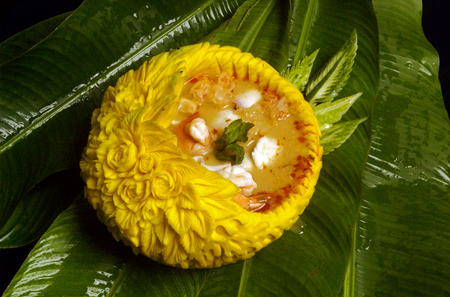 Thai shrimp spicy soup serve in bowl carved from pumpkinの写真素材