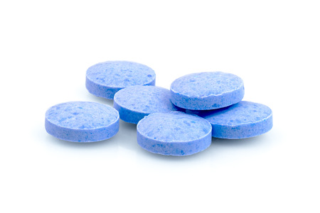 Blue pills close up circle shape macro photography drug on  white backgroundの写真素材