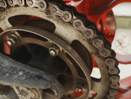 Closeup Old Chain and Sprocket motorcycle with soil and mud stains.